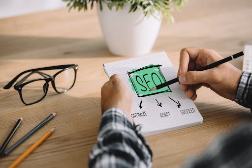 cropped shot of seo manager writing plan in notebook at workplace seo animation image